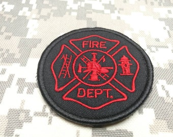 May include: Black embroidered patch with a red fire department symbol. The symbol is a cross with a ladder, a fire hydrant, and a fire tower. The text "FIRE DEPT." is written in red.