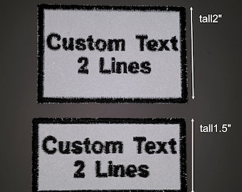 1 pz. Toppa riflettente con 2 righe di testo personalizzato e nome ricamato.