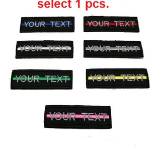 May include: Six embroidered patches with black backgrounds and different colored stripes. The patches have the text "YOUR TEXT" in white.