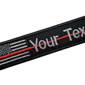 May include: Black embroidered patch with a thin red line through the middle of an American flag and the text "Your-Text" in white.