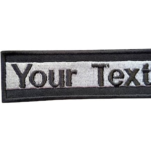 May include: Black and white embroidered patch with the text "Your Text" on a white background.