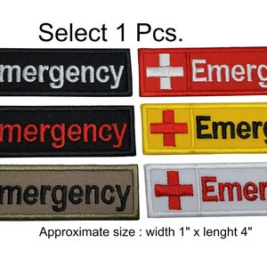 Peut inclure: Écussons rectangulaires brodés avec une croix rouge et le mot "Emergency". Disponibles en noir, rouge, jaune, beige et blanc. Chaque écusson mesure environ 2,5 cm de large et 10 cm de long.