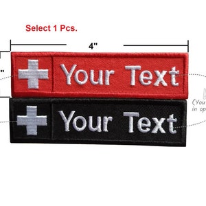 May include: Two embroidered patches, one red and one black, with a white Swiss cross and the text "Your Text". The patches are 4 inches long and 1 inch wide. You can choose the color of the text.