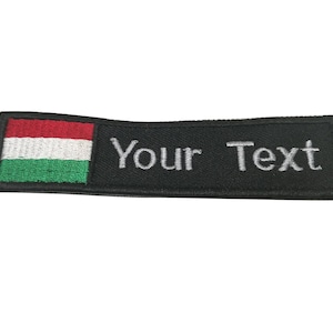 May include: Black embroidered patch with the Hungarian flag on the left and the text "Your Text" on the right.