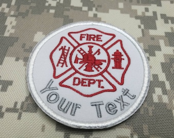 May include: White embroidered patch with a red fire department logo. The logo features a fire hydrant, an axe, a ladder, and the words "FIRE DEPT". The patch has the text "YOUR TEXT" below the logo.