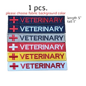 May include: Six embroidered patches with a red cross and the word "VETERINARY" in white lettering. The patches are available in six different colors: red, navy blue, gray, yellow, white, and black. Each patch is 5 inches long and 1 inch tall.