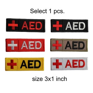 May include: Six embroidered patches with a red cross and the letters "AED" in different colors. The patches are 3 inches by 1 inch and are available in black, white, red, yellow, beige, and gray.