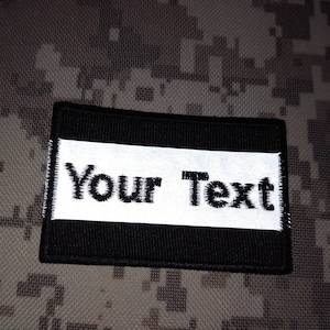 May include: Black and white patch with the text "Your Text" in white on a black background.