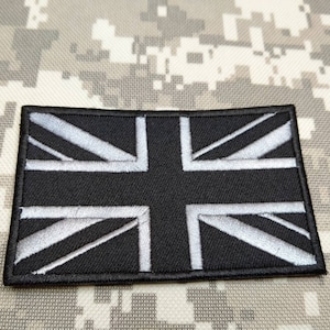 May include: Black embroidered patch with a white Union Jack flag design.