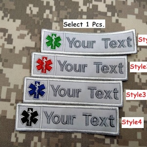 May include: Four different styles of embroidered patches with a medical symbol and the text "Your Text". The patches are on a gray background and have different colored medical symbols: green, red, blue, and black.
