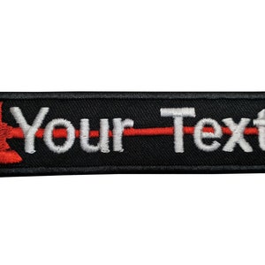 May include: Black embroidered patch with a red axe and white text that says "Your Text".