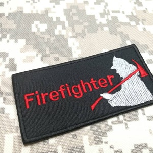May include: Black embroidered patch with the word "Firefighter" in red lettering and a white silhouette of a firefighter holding an axe.