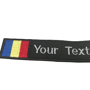 May include: Black embroidered patch with the Romanian flag and the text "Your Text" in white.