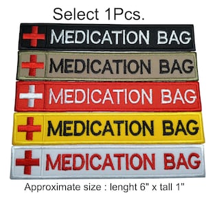 May include: Five embroidered patches with a red cross and the text "MEDICATION BAG" in black, white, or red lettering. The patches are on a white background and are arranged vertically. The patches are approximately 6 inches long and 1 inch tall.