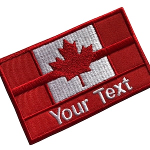 Puede incluir: Parche bordado con el diseño de la bandera canadiense, con una hoja de arce roja sobre un fondo blanco. El parche tiene un borde rojo e incluye el texto "Your Text" en blanco.