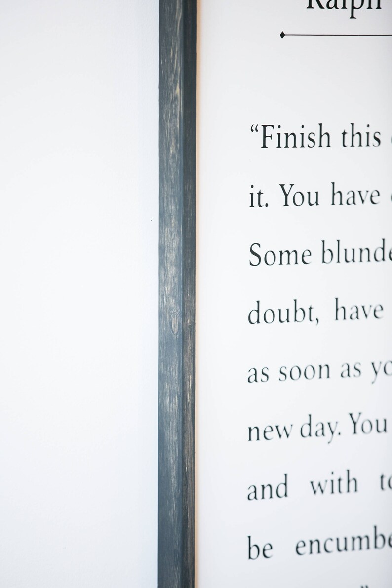 May include: A framed print with a black wood frame and a white background. The print features a quote that reads "Finish this it. You have Some blunde doubt, have as soon as yo new day. You and with to be encumbe"
