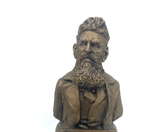 May include: A bronze bust of John Brown, a historical figure, on a wooden base. The bust depicts Brown with a beard and a serious expression. The base has an inscription that reads: "I, John Brown, am now quite certain that the crimes of this guilty land can never be purged away but with blood."
