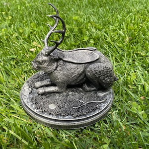 Jackalope statue in “catloaf” pose