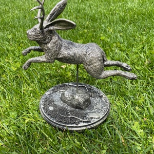 Jumping jackalope statue