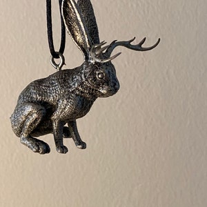 Jackalope ornament in “chocolate bunny” pose