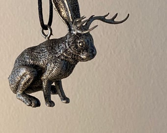 Jackalope ornament in “chocolate bunny” pose