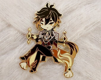 May include: Gold-colored enamel pin featuring a cartoon character with brown hair, wearing a black and white outfit, holding a cup. The character is sitting on a gold-colored throne with a diamond pattern.