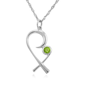 May include: A silver-toned pendant necklace featuring a stylized heart design. The pendant incorporates a bright green, round gemstone. The necklace chain is a delicate, twisted rope style. The jewelry is displayed against a white background.