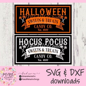 May include: Two black and orange Halloween-themed signs with white text. The top sign says "Halloween Sweets & Treats Candy Co. Est. 1692". The bottom sign says "Hocus Pocus Sweets & Treats Candy Co. Est. 1692".
