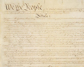 May include: A historical document on aged, off-white parchment paper featuring dark brown cursive calligraphy. The text begins with the prominent heading We the People and continues with Article 1, displaying dense, handwritten legal script throughout.