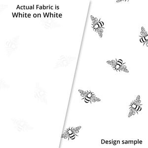 May include: A white background with a black and white bee pattern. The text "Actual Fabric is White on White" is at the top left of the image. The text "Design sample" is at the bottom right of the image.