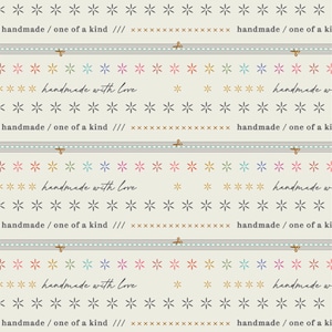 May include: A repeating pattern of colorful stars and the text "handmade with love" and "handmade / one of a kind" on a beige background.