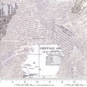 May include: A white fabric with a vintage newspaper print design. The fabric features a map of Central America, a ruler, and the text "LOVE BOOK MAGAZINE" and "DREAM DATE".