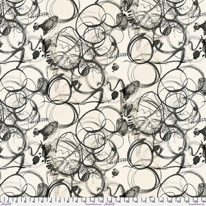 May include: A fabric swatch featuring a cream background with a repeating black charcoal-style sketch pattern of overlapping circles, scribbles, and dots. A white ruler with black markings from 0 to 24 inches is visible along the bottom edge.