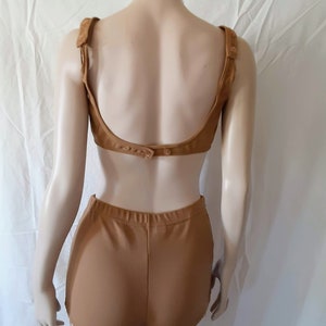 May include: A brown two-piece swimsuit with a low back and high-waisted bottoms.