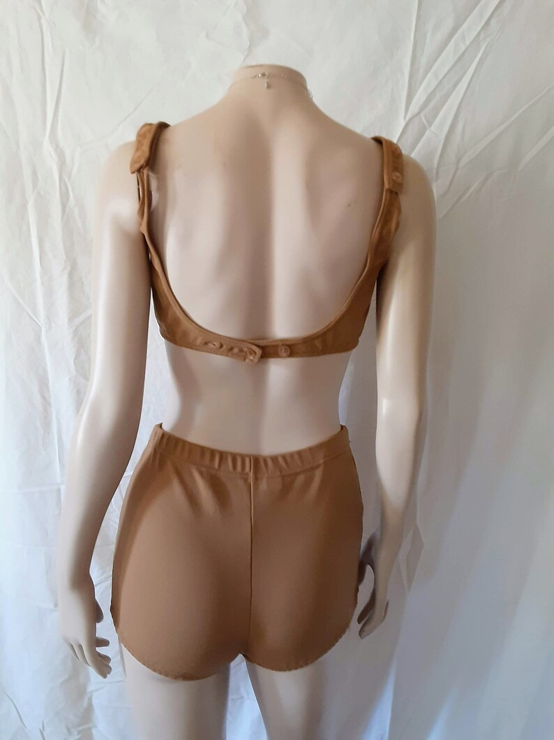 May include: A brown two-piece swimsuit with a low back and high-waisted bottoms.