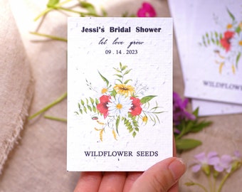 May include: A white card with a floral design and the text "Jessi's Bridal Shower let love grow 09.14.2023 Wildflower Seeds".