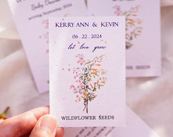 May include: A white card with a floral design and the text "Kerry Ann & Kevin 06.22.2024 let love grow" and "Wildflower Seeds".