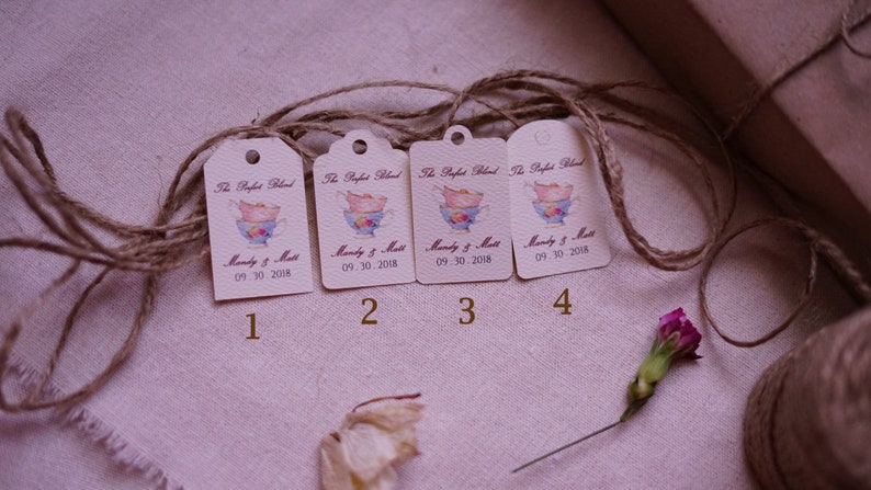 May include: Four brown paper gift tags with a watercolor illustration of a teacup and the text "The Perfect Blend" and "Mandy & Matt" with the date "09.30.2018".