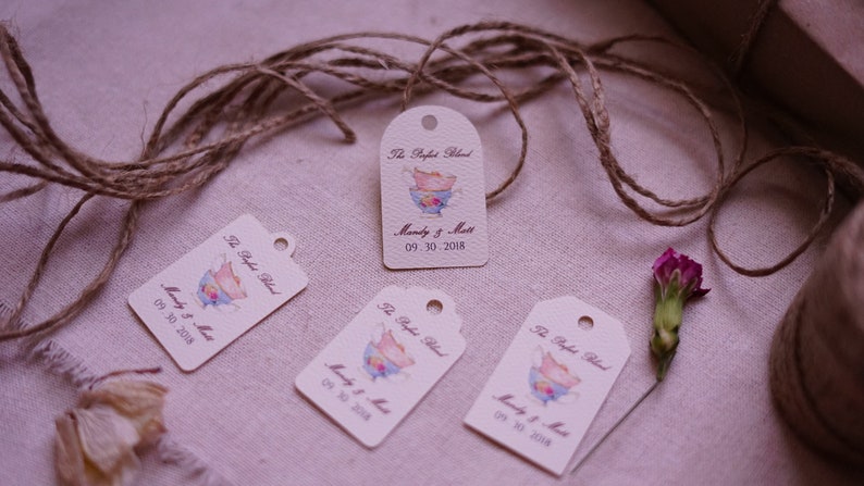 May include: Four cream-colored gift tags with brown twine. Each tag features a watercolor illustration of a teacup and saucer with the text "The Perfect Blend" and "Mandy & Matt" with the date "09.30.2018".