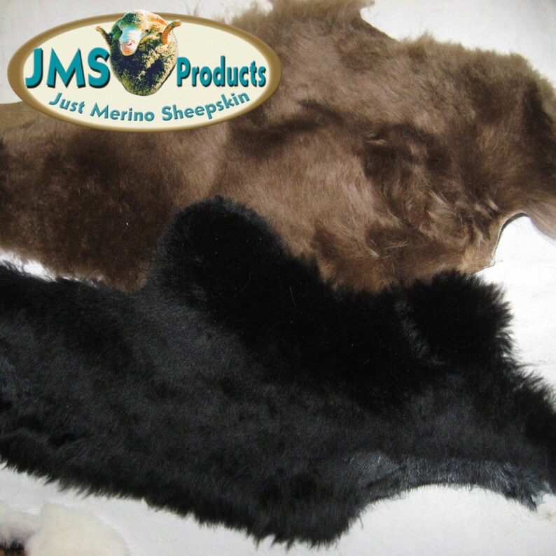 May include: Two sheepskin rugs, one brown and one black, with the text "JMS Products Just Merino Sheepskin" on a white oval label.