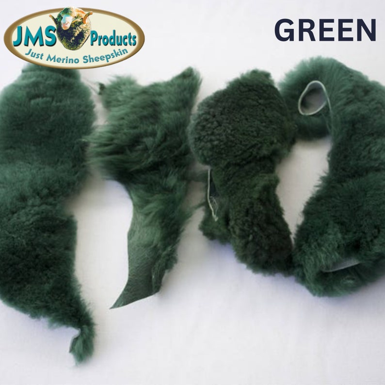 May include: Four pieces of green sheepskin fur. The fur is soft and fluffy. The pieces are different shapes and sizes. The fur is a deep green colour. The fur is labelled "GREEN".