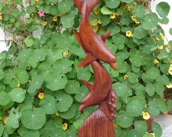 Wooden sculpture jumping dolphins