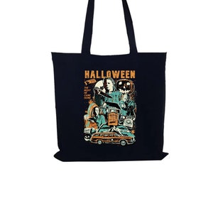 May include: Black canvas tote bag with a Halloween themed graphic featuring characters from the movie Halloween. The graphic includes the text "Halloween" and "The Night He Came Home".