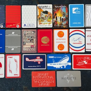 May include: A collection of twenty-two rectangular airline playing cards featuring various vintage logos and illustrations from carriers including Delta, Pan Am, United, Continental, Air Jamaica, Piedmont, Northwest, TWA, American, and Braniff.