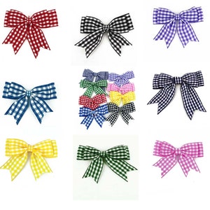 May include: A selection of gingham bows in a range of colours, such as red, black, blue, purple, green, yellow, and pink. The bows are displayed against a white backdrop, highlighting their checkered patterns and decorative design.