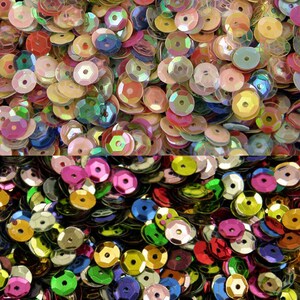 May include: Assortment of iridescent sequins in various colours, including pink, blue, green, gold, and silver. The sequins are arranged in a random pattern and are perfect for crafting and decorating.