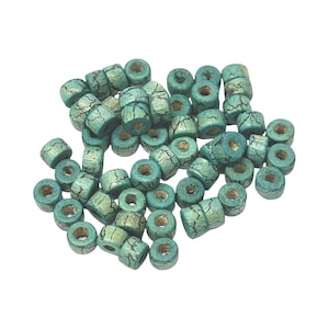 May include: A pile of turquoise wooden beads with a distressed, crackled effect. The cylindrical beads have a central hole, perfect for threading. The beads are scattered on a white background, suitable for jewellery making or craft projects. Each bead measures approximately 0.6 cm.