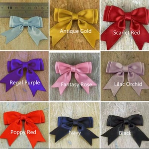 May include: Nine different colours of satin ribbon bows. The colours are antique gold, scarlet red, regal purple, fantasy rose, lilac orchid, poppy red, navy, and black.