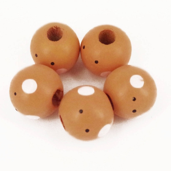 wooden doll heads with faces