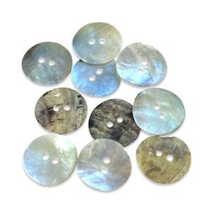 May include: A collection of 10 round, iridescent, mother-of-pearl buttons with two holes each. The buttons are in various shades of blue, white, and brown.
